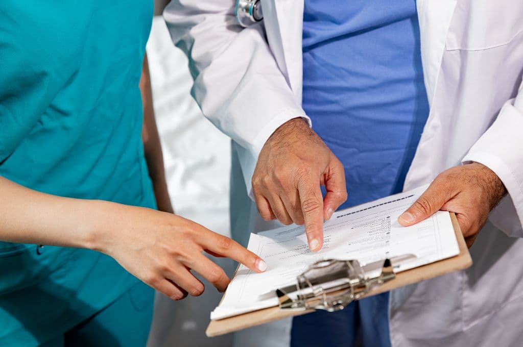 Medical professionals reviewing patient records, highlighting the importance of accuracy and detail in medical billing and coding certification training in Texas.