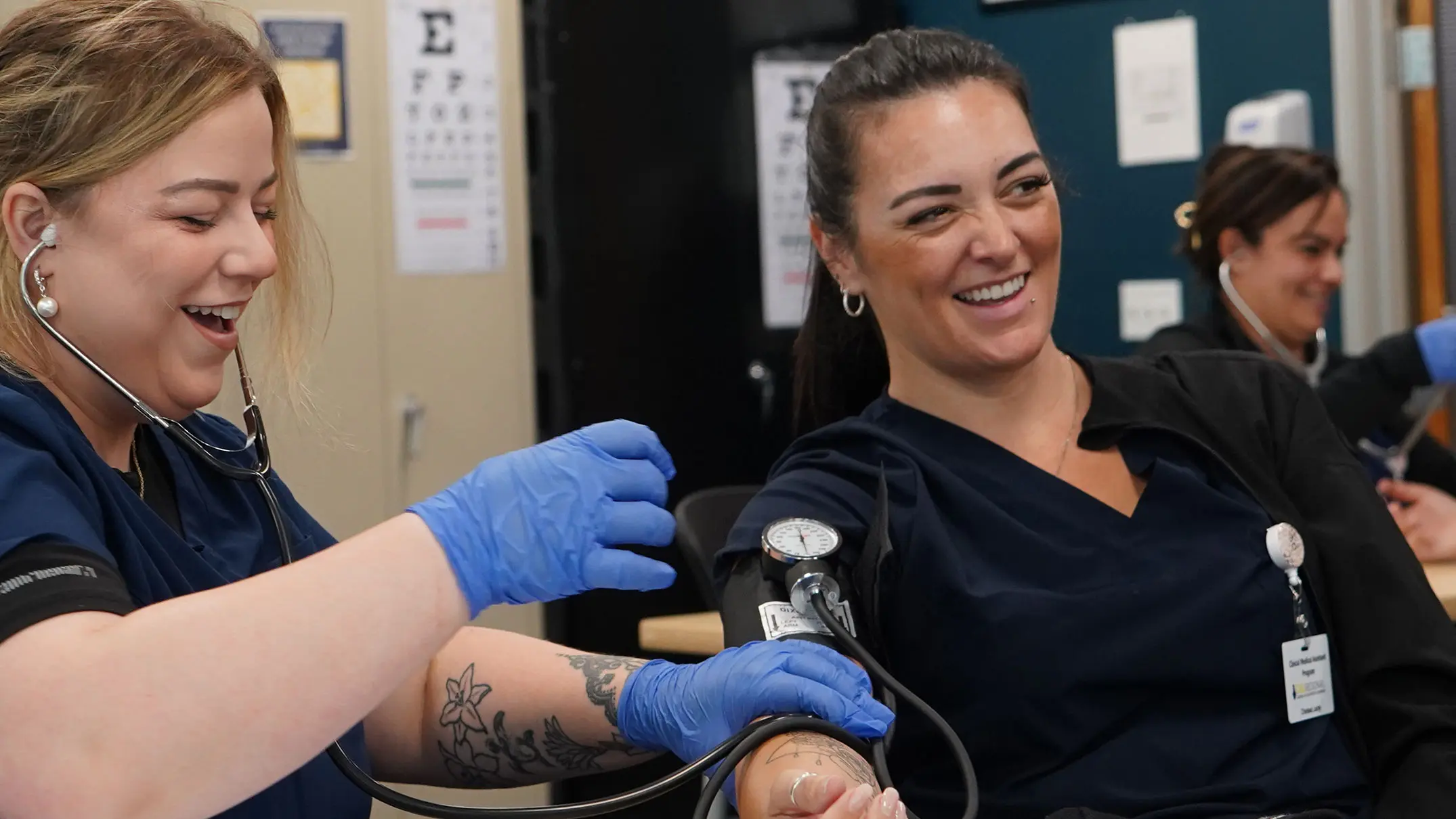 Two Medical Students Practicing and Laughing