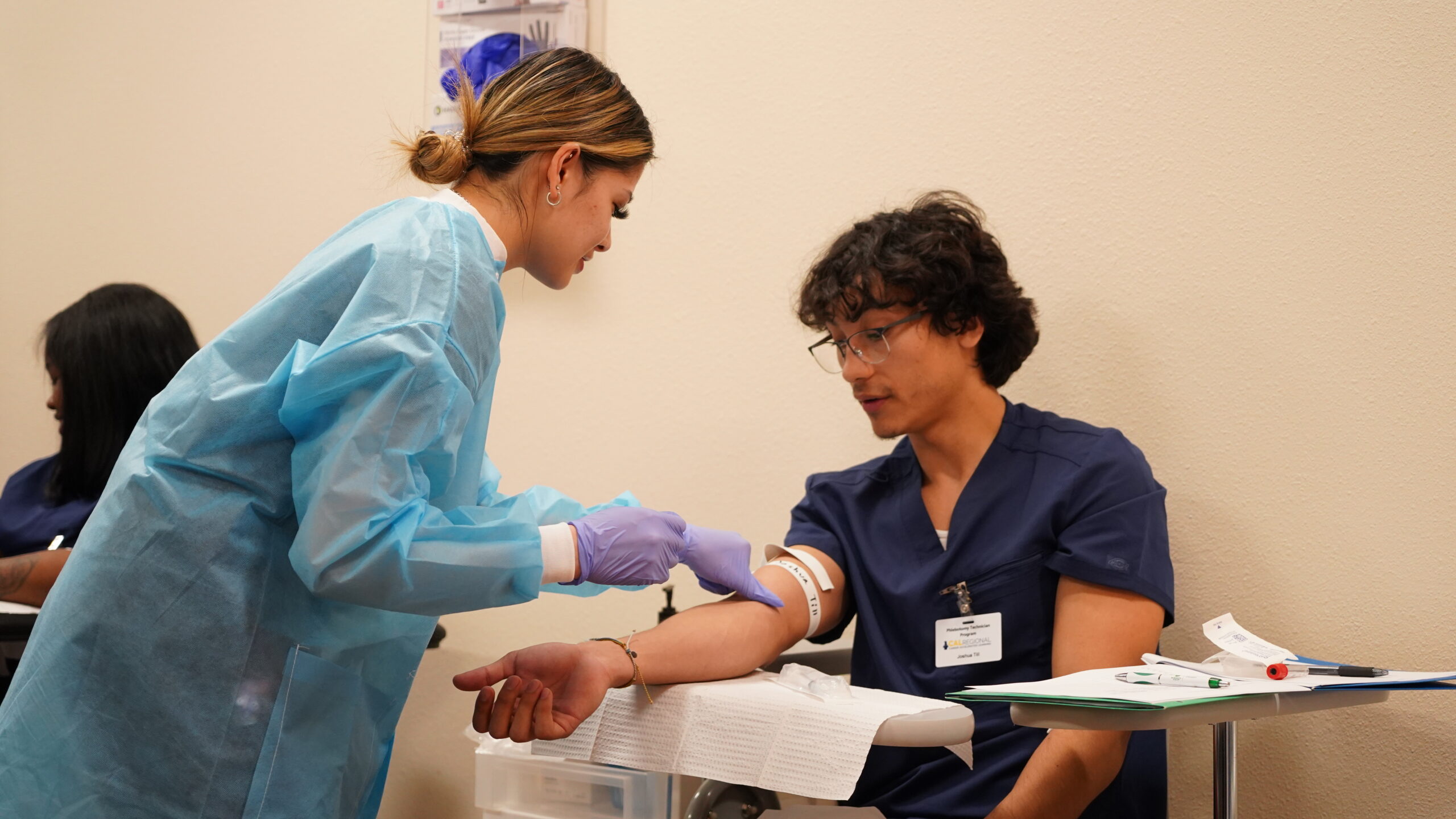 Phlebotomy student completing a blood draw during a clinical externship in a CALRegional-administered program near San Bernardino.