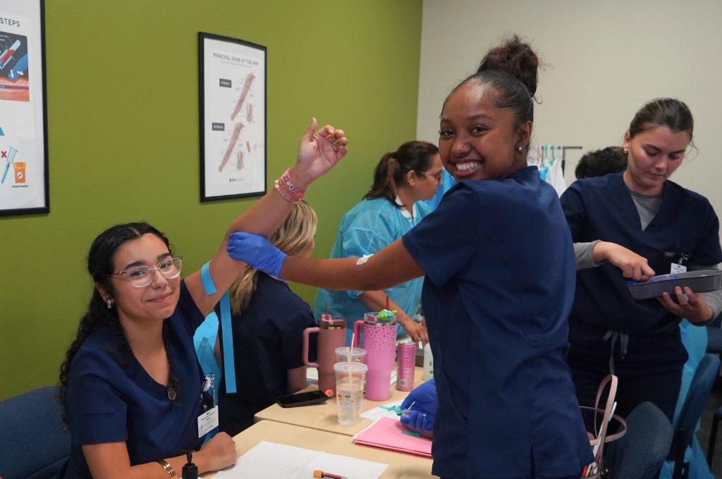 Phlebotomy students in Beaumont, CA practicing blood draws during hands-on training at Beaumont Adult School.