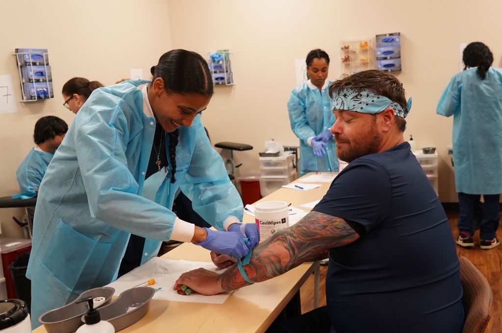 Phlebotomy student practicing blood draw during CALRegional-administered training near Anaheim, CA.