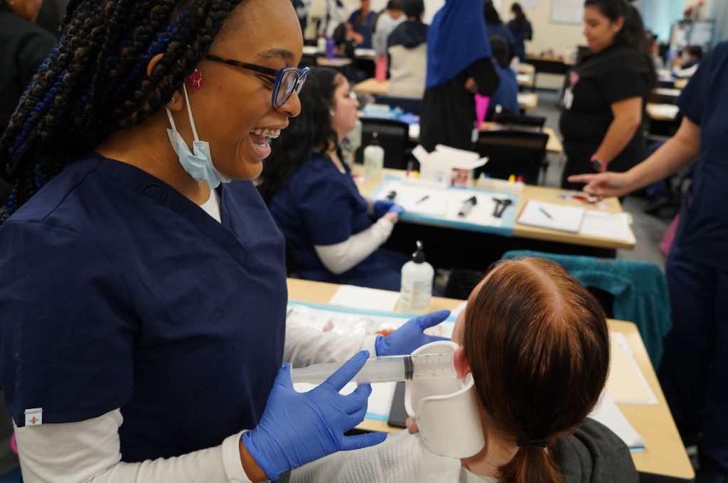 Medical assistant student practicing patient care skills during classroom training in Antioch CA